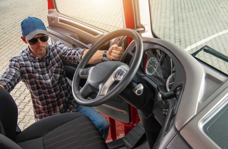 A fleet driver prepares to get into the cab of his fleet.